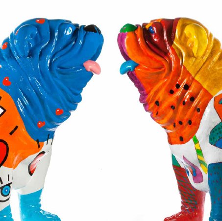 Two colorful, stylized dog sculptures facing each other, one painted mostly in blue hues and the other in warm tones.