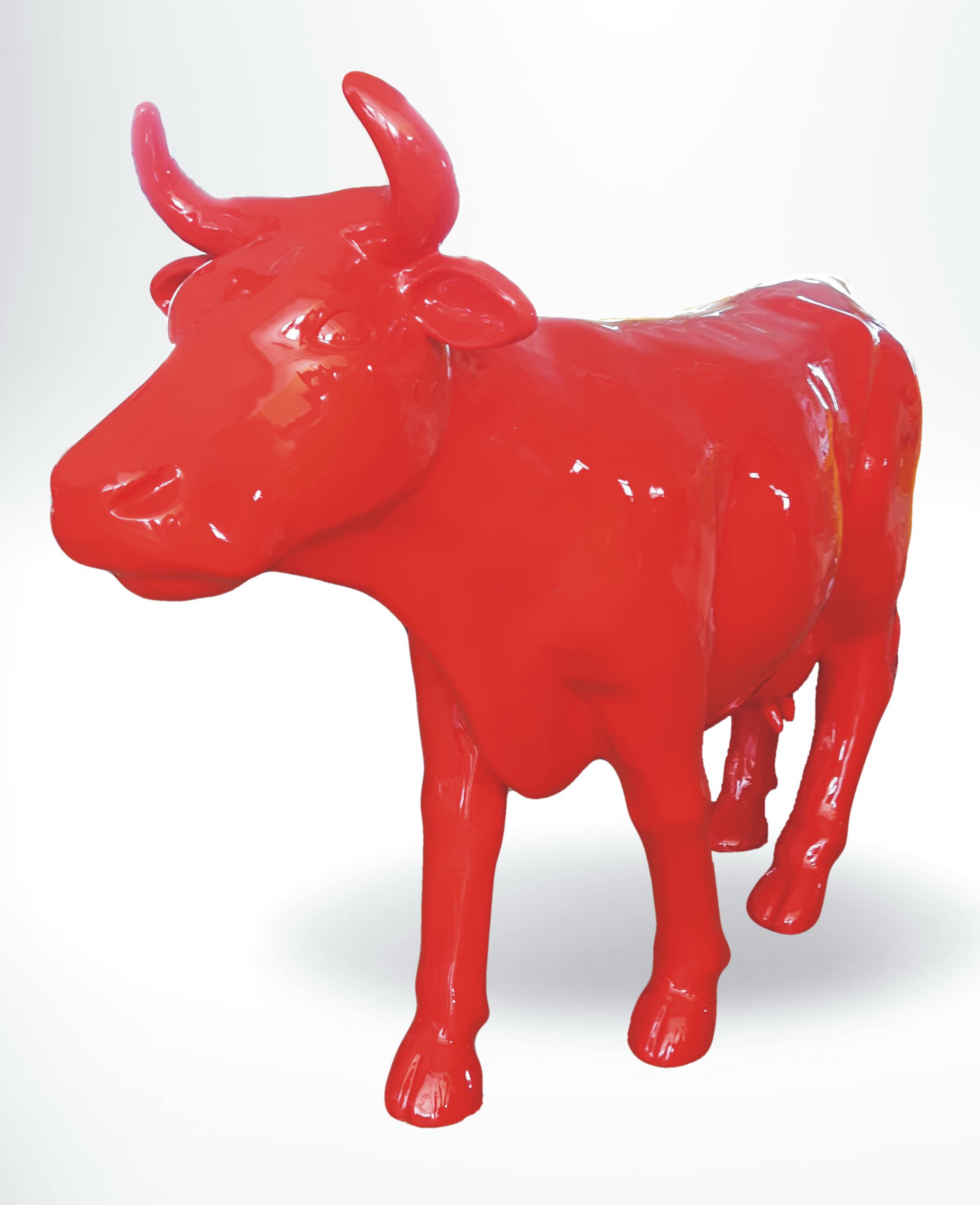 Fiberglass Cow Life Size Statue - Single Color 8 A bright red sculpture of a cow with prominent horns.