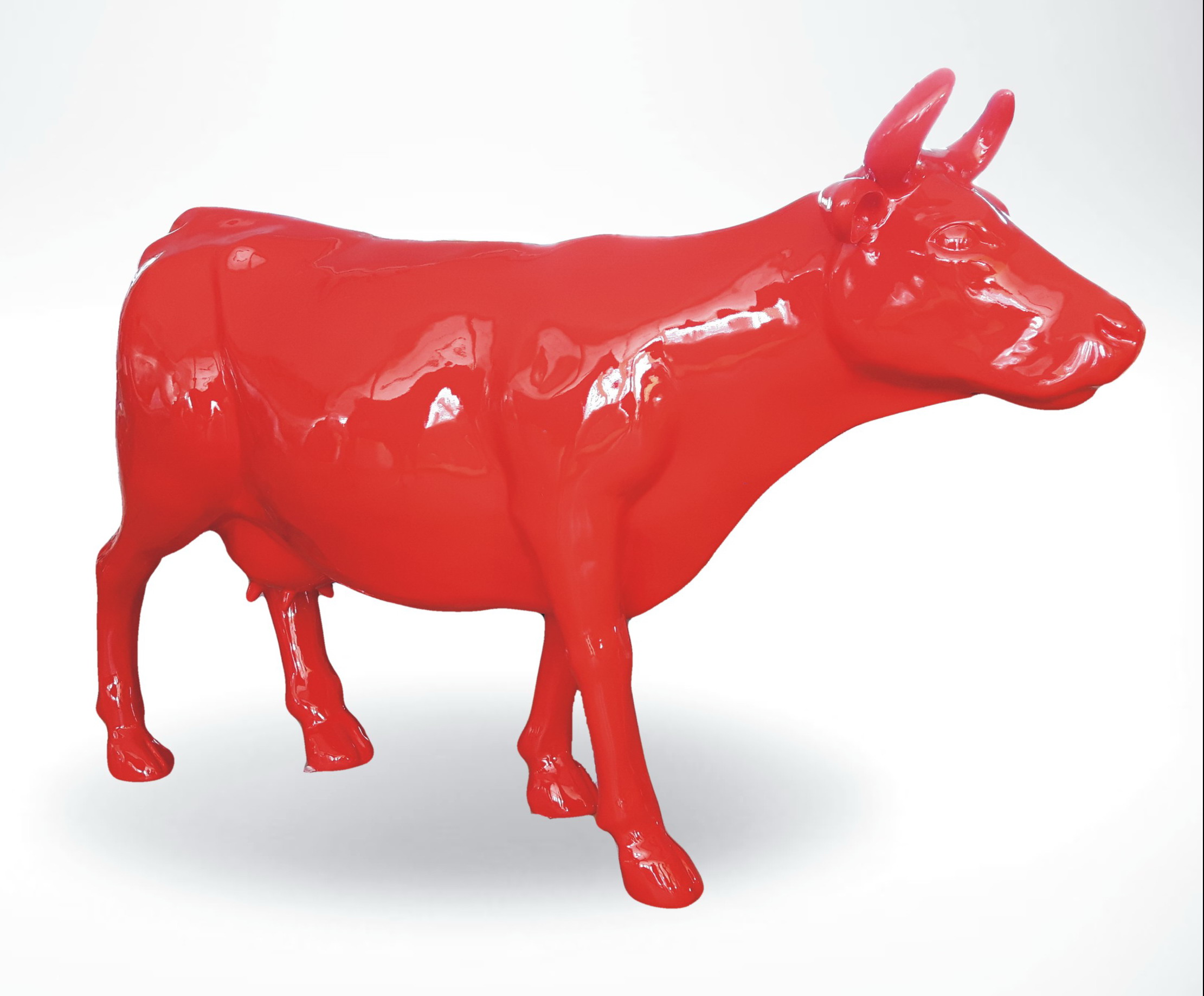 Fiberglass Cow Life Size Statue - Single Color 7 A bright red, glossy statue of a cow on a white background.