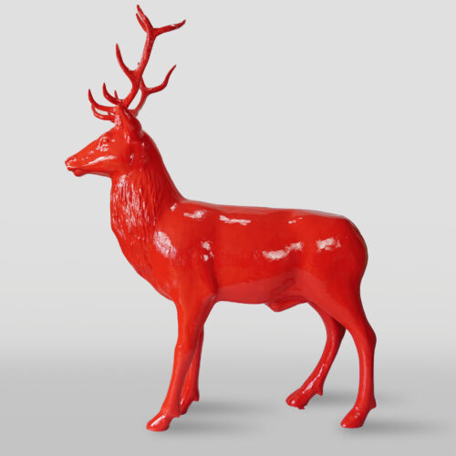 Red deer sculpture with prominent antlers.