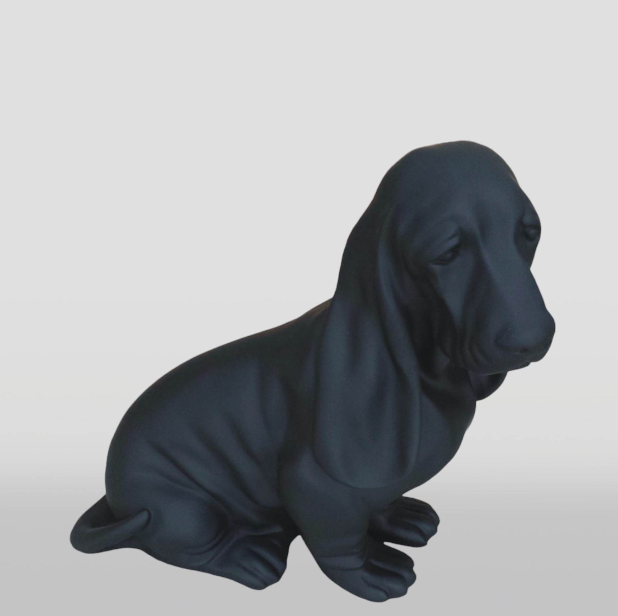 Basset Hound Seated Resin Figure - Single Color 2 Black matte statue of a basset hound dog in a seated position against a white background.