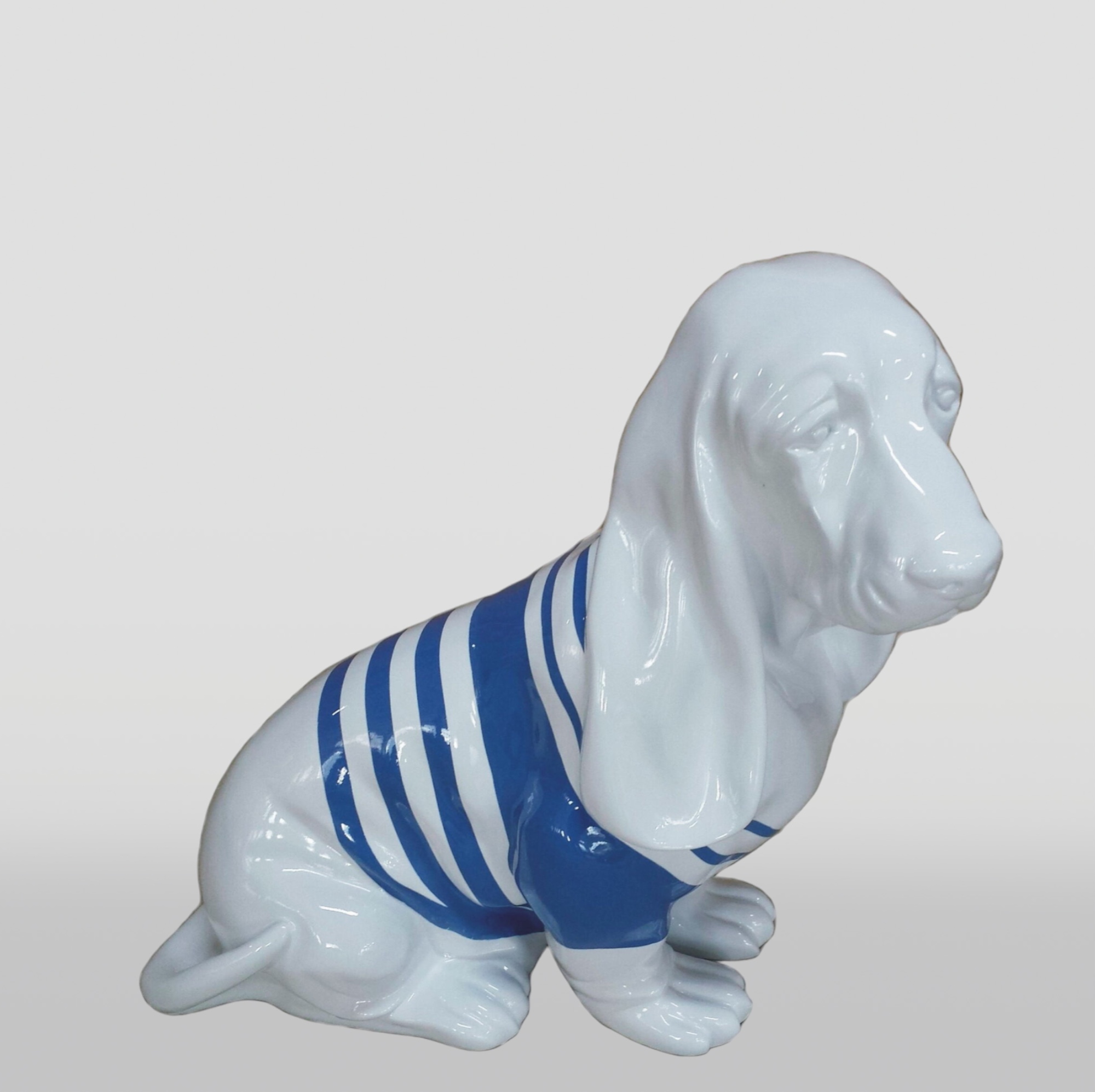 Basset Hound Seated Resin Figure - Single Color 3 Ceramic dog figurine wearing a blue and white striped shirt.