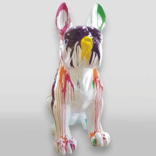 A white French Bulldog sculpture with colorful paint drips in various colors including pink, yellow, green, and purple.