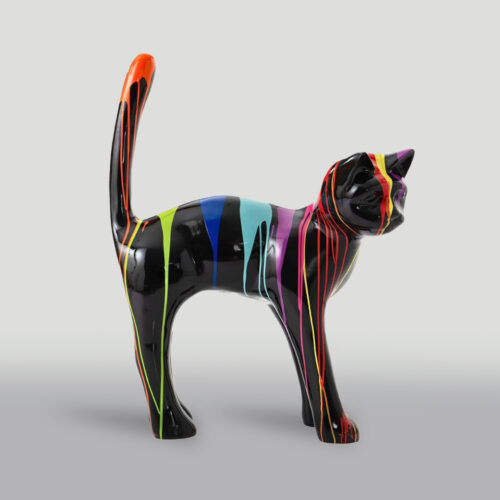 A black ceramic cat figurine with colorful paint drips in red, yellow, green, blue, pink, and purple.