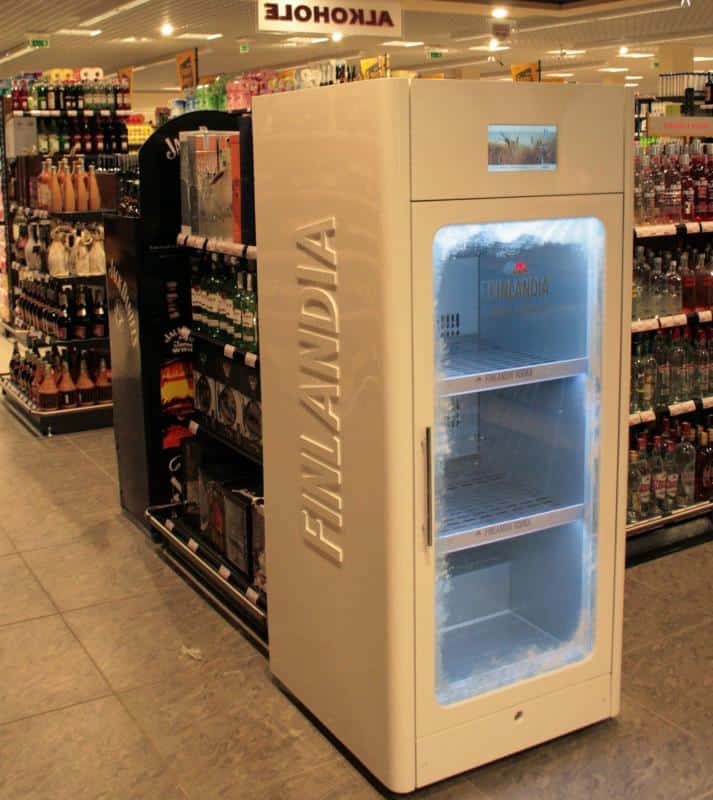 A large, white Finlandia-branded freezer in a liquor store aisle.