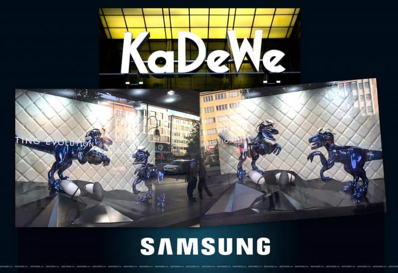 KaDeWe store signage and Samsung display featuring robotic dinosaurs in a window exhibit.