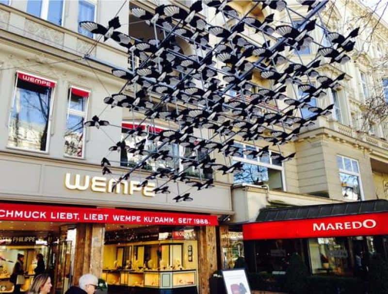 oryg_064490685_1129949550544944_1465385417682452480_o Shopfronts of Wempe and Maredo with a decorative display of black bird cutouts suspended in the air.