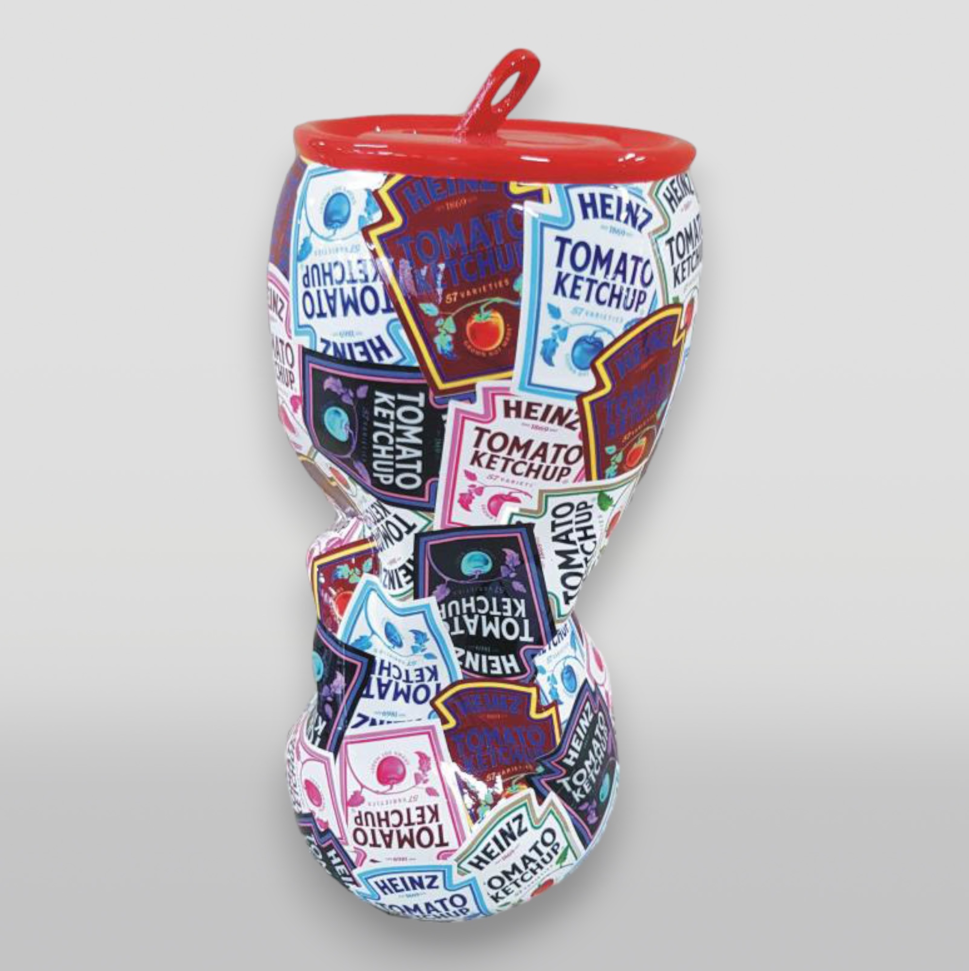 Pop art wrapping can, a functional and decorative figure. 3 A curved ceramic vase with a red rim and handle, covered in various colorful Heinz Tomato Ketchup label designs.