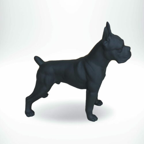 Black dog figurine in a standing position against a plain white background.