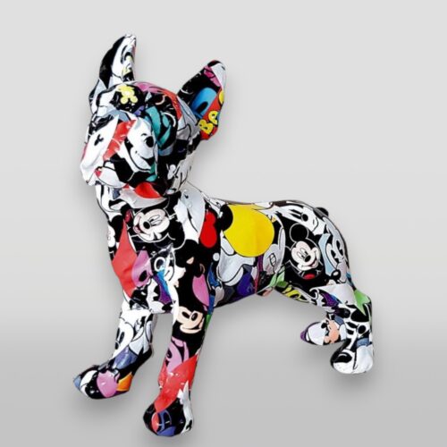 Sculpture of a dog covered in a colorful, cartoon-themed collage.