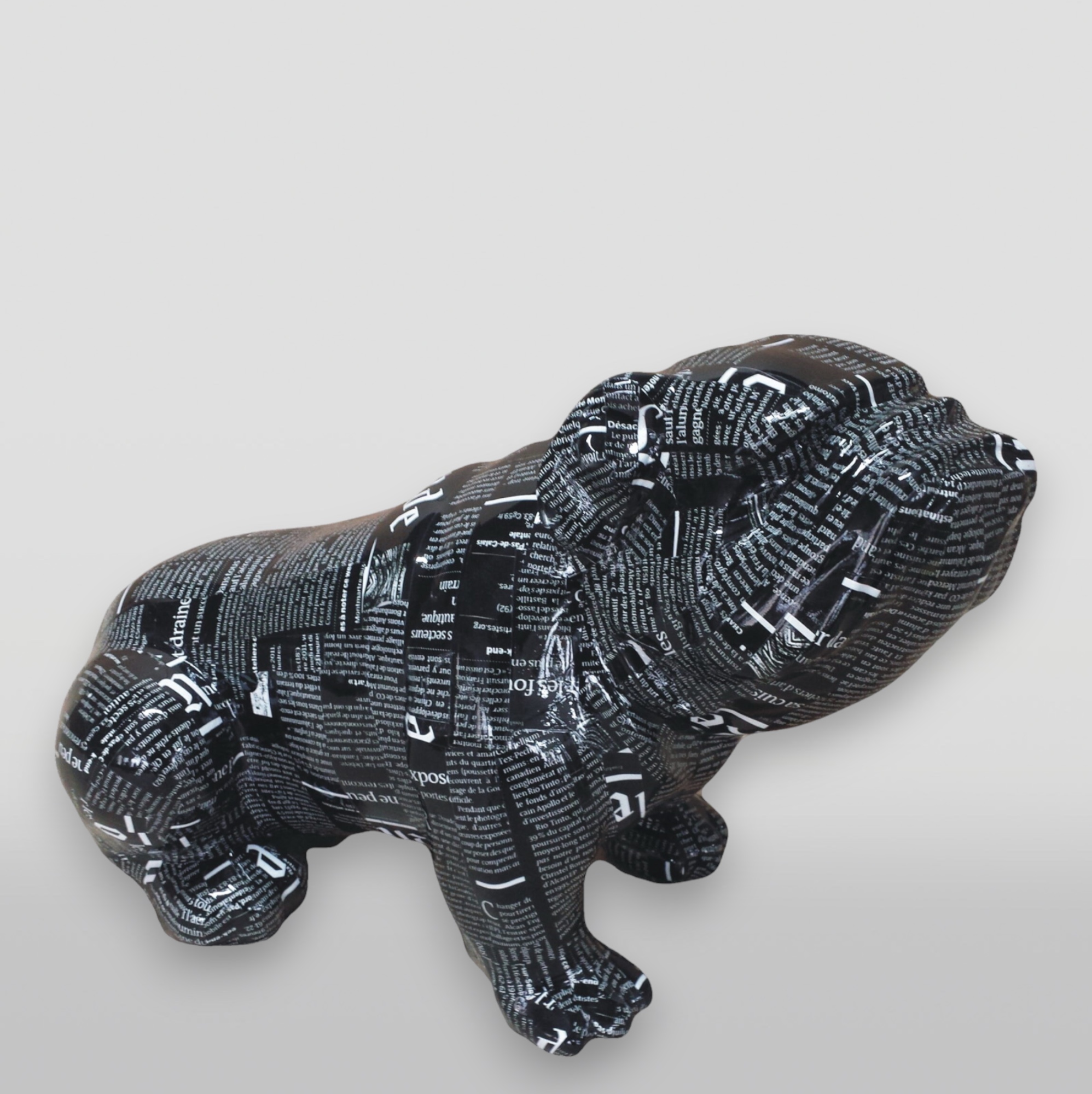 Resin Handmade Figurine Seated English Bulldog - Pop -art 1 Sculpture of a dog covered with a collage of black and white text.