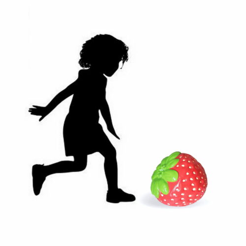 Silhouette of a child playing next to a large strawberry.