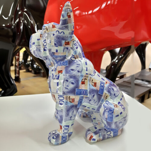A sculpture of a dog covered in decals of Swedish 100-krona banknotes.