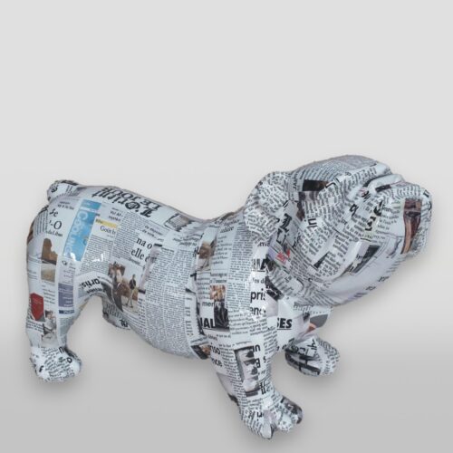 Paper mache bulldog covered in newspaper clippings.