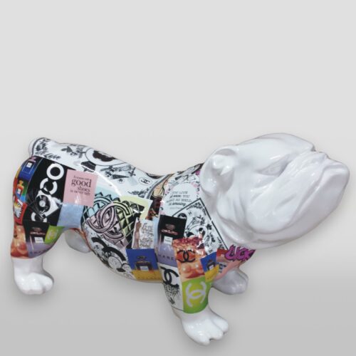 White ceramic bulldog sculpture with a body covered in various colorful collage images and logos, including Chanel and perfume bottles.