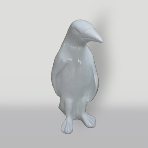 White ceramic penguin statue with a gloss finish against a neutral background.