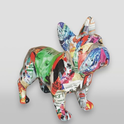 Colorful French bulldog sculpture decorated with various vibrant mixed media collage materials.