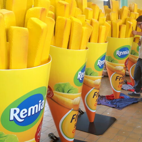 Rows of large yellow cones filled with fake fries labeled with 
