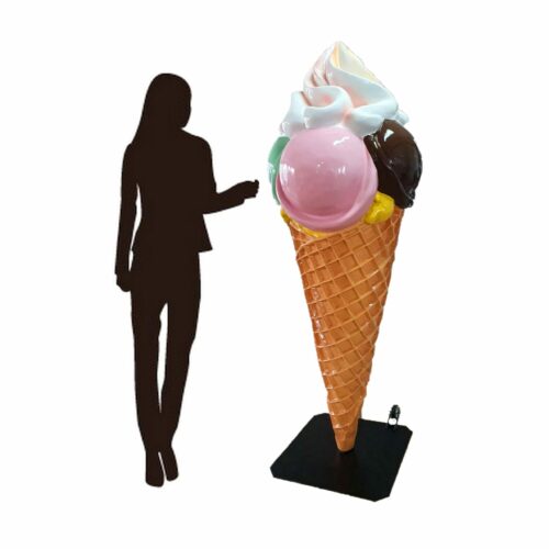 A silhouette of a person standing next to a large ice cream cone sculpture with colorful scoops and whipped cream.