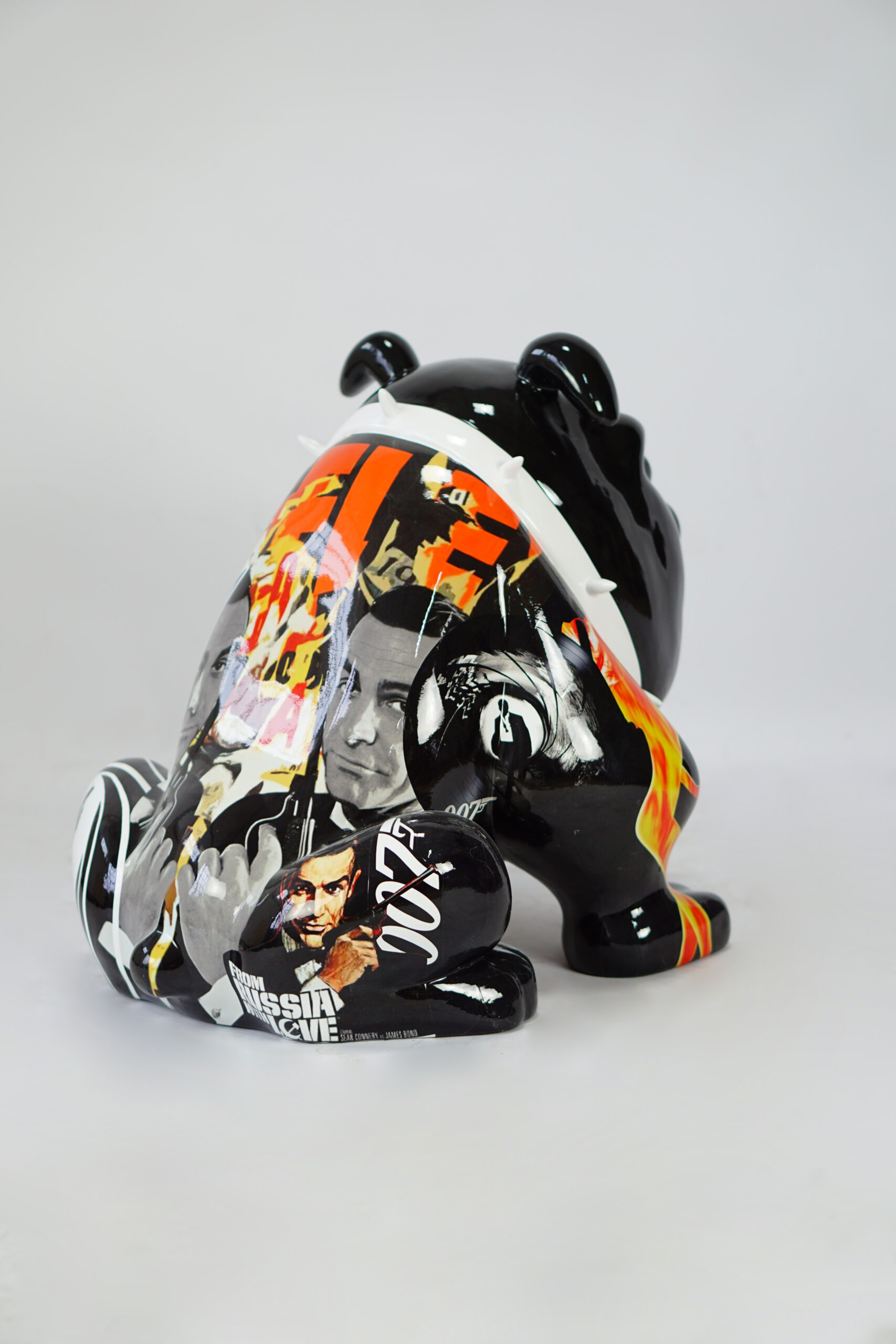 Bulldog Avella 55cm dog - James Bond 3 Black bear sculpture with collage artwork featuring images from James Bond movies, including flames and the number