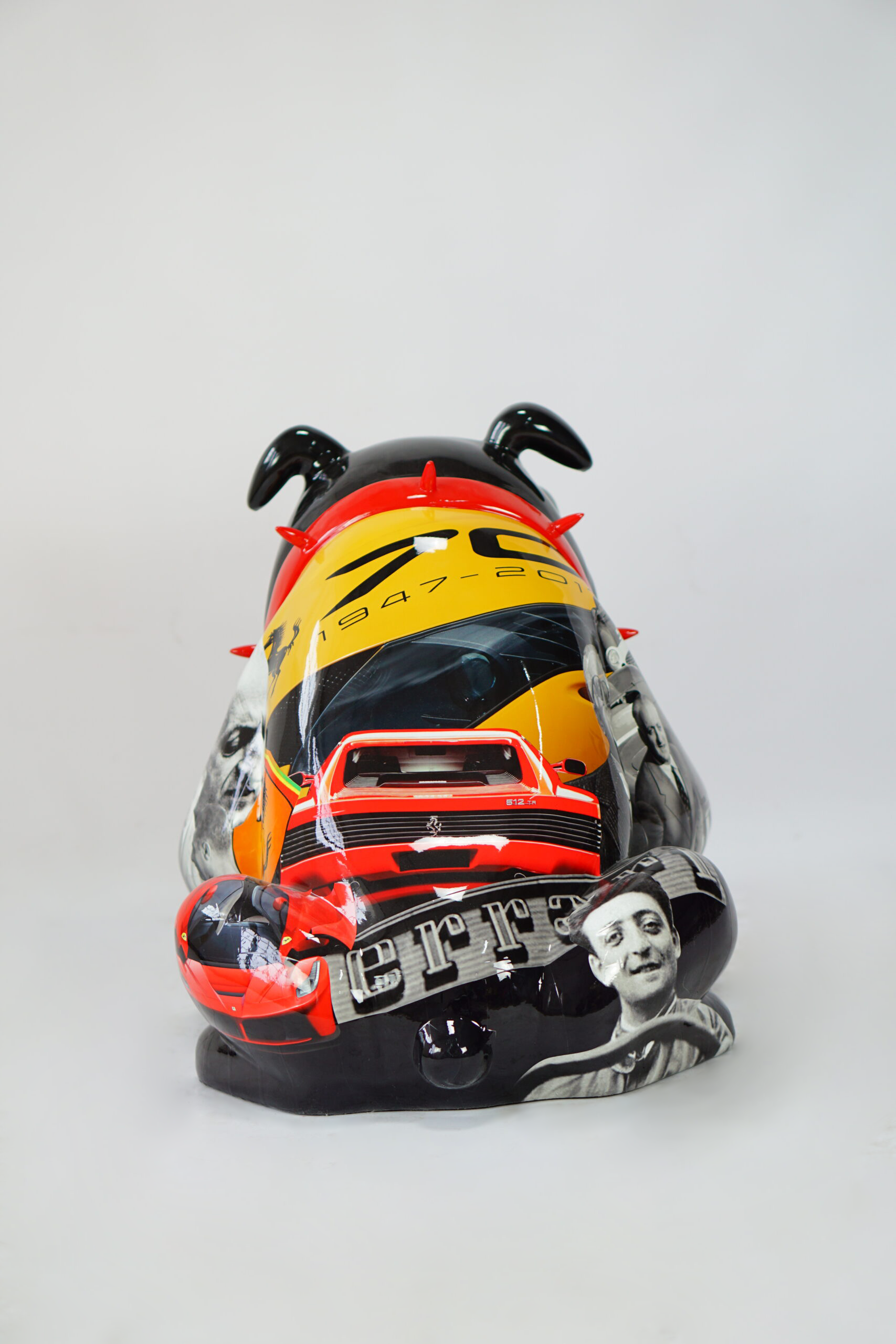 Bulldog Avella 55cm dog - Ferrari 4 A sculpture in the shape of a bulldog decorated with Ferrari-themed images, including a red Ferrari car, the Ferrari logo, the text