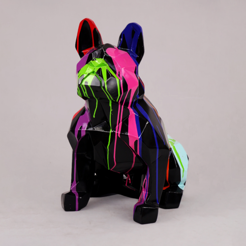 Geometric dog statue with colorful paint streaks in pink, green, blue, and black.
