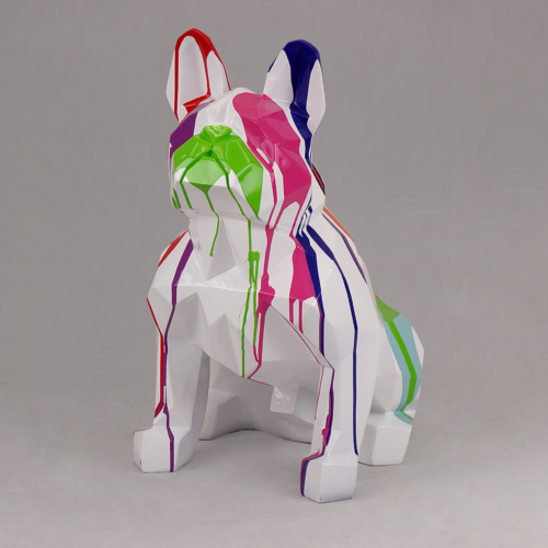 A white sculpture of a French Bulldog with colorful paint drips in red, green, blue, pink, and purple.