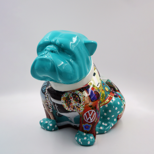 Colorful ceramic bulldog statue with a teal head and polka-dotted legs, decorated with various patterns and symbols.