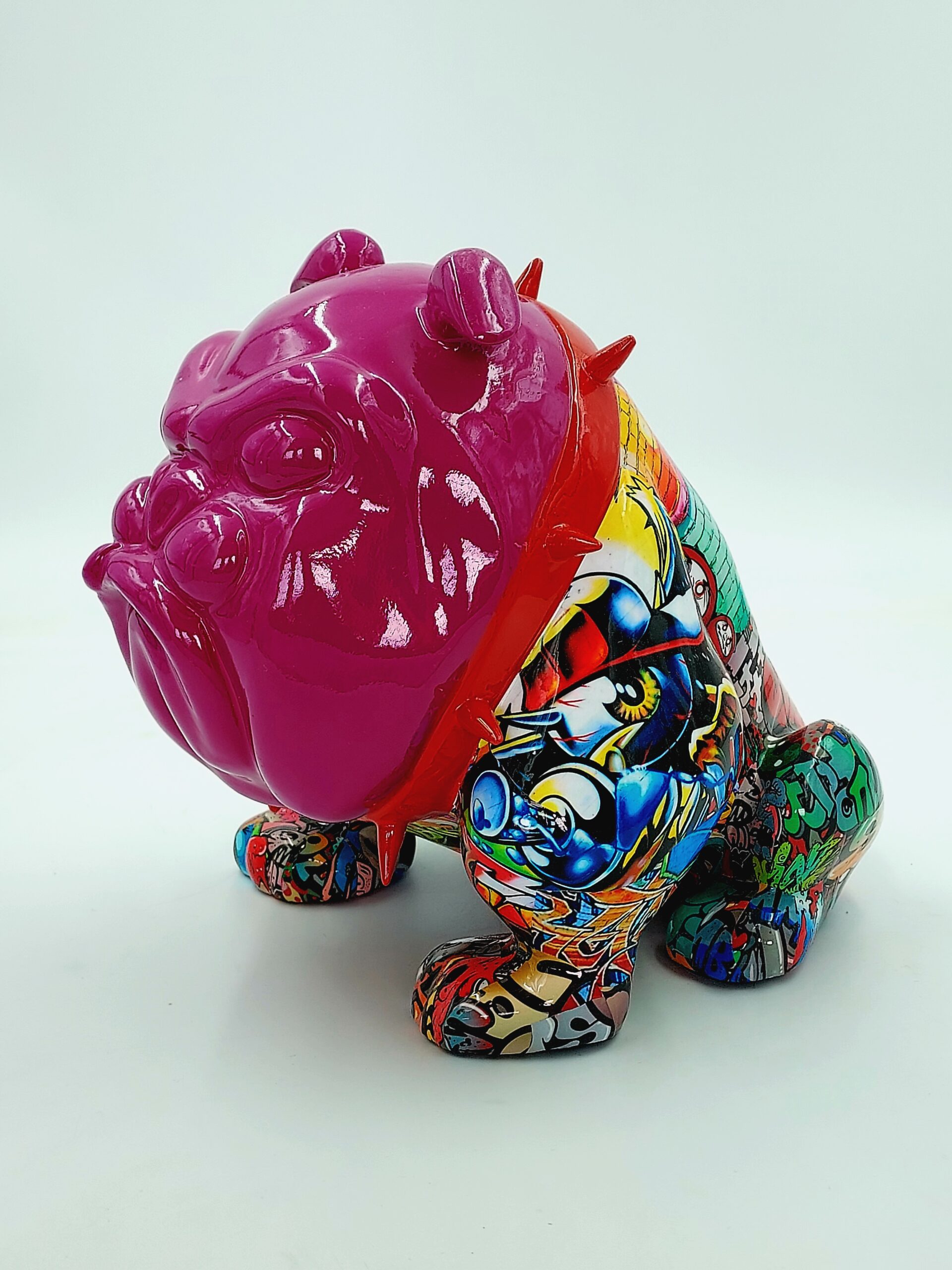 Bulldog Avella Dog 55cm - graffiti 1 Colorful bulldog sculpture with a pink head and a body covered in vibrant graffiti-style artwork.