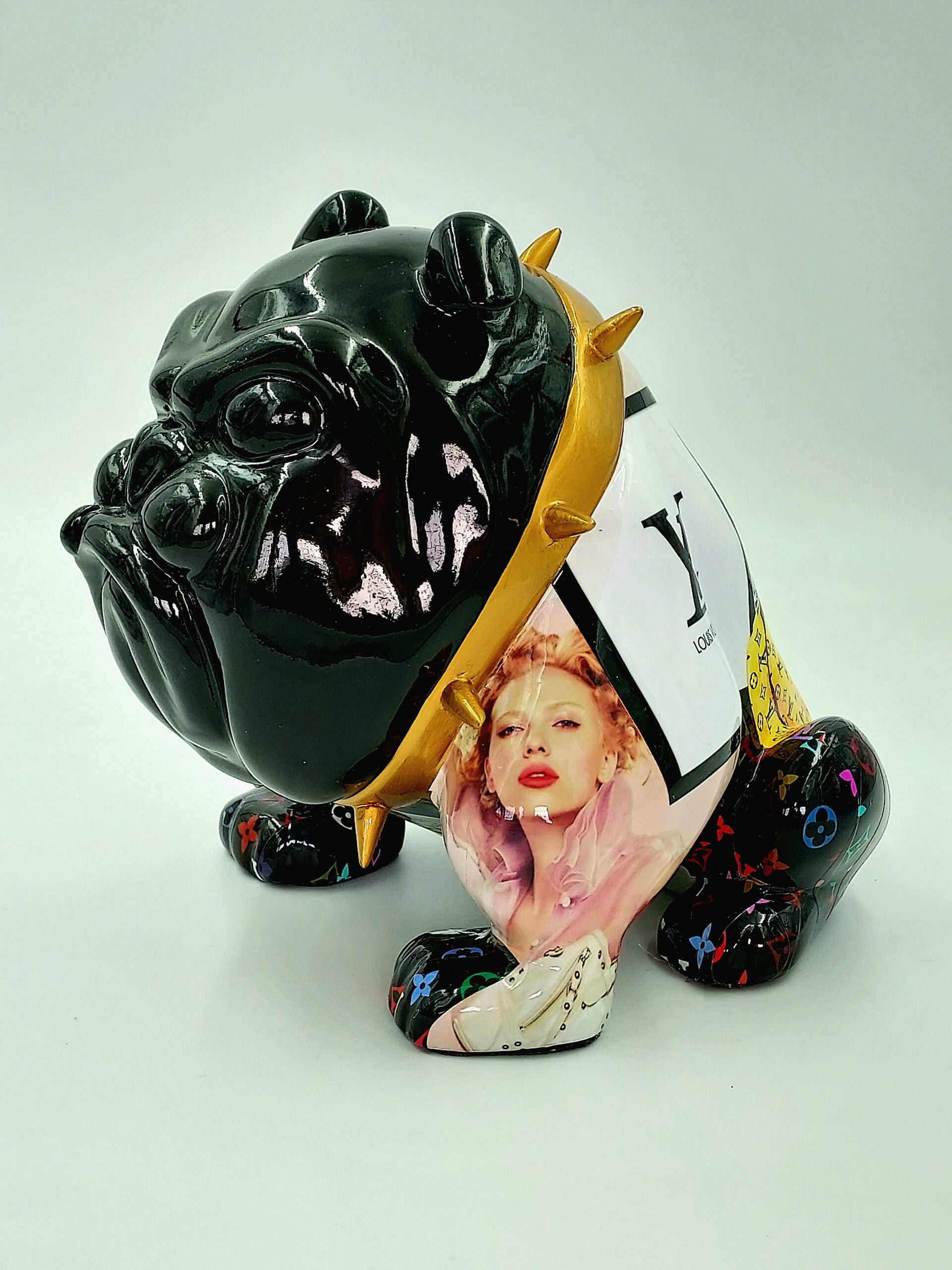 Bulldog Avella Dog 55cm - L 1 Black ceramic bulldog figurine adorned with a golden spiked collar and colorful patterns, featuring an image of a woman's portrait on its side.
