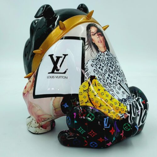 Ceramic sculpture of a bear with collage elements featuring images, Louis Vuitton branding, and multicolored patterns.