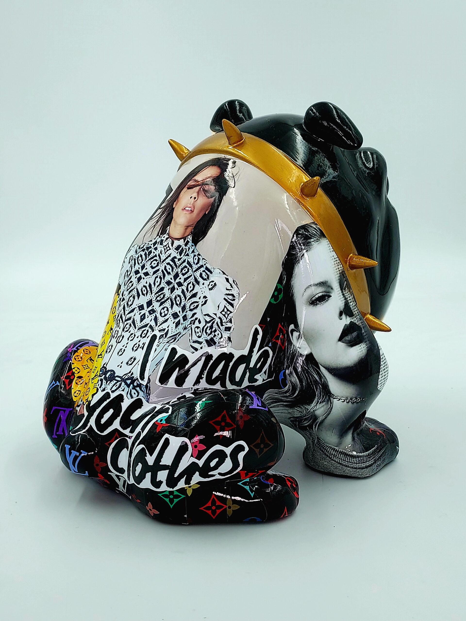 Bulldog Avella Dog 55cm - L 3 Decorative statue of a black anthropomorphic figure wearing a spiked gold collar, featuring collage images of two women, and text stating