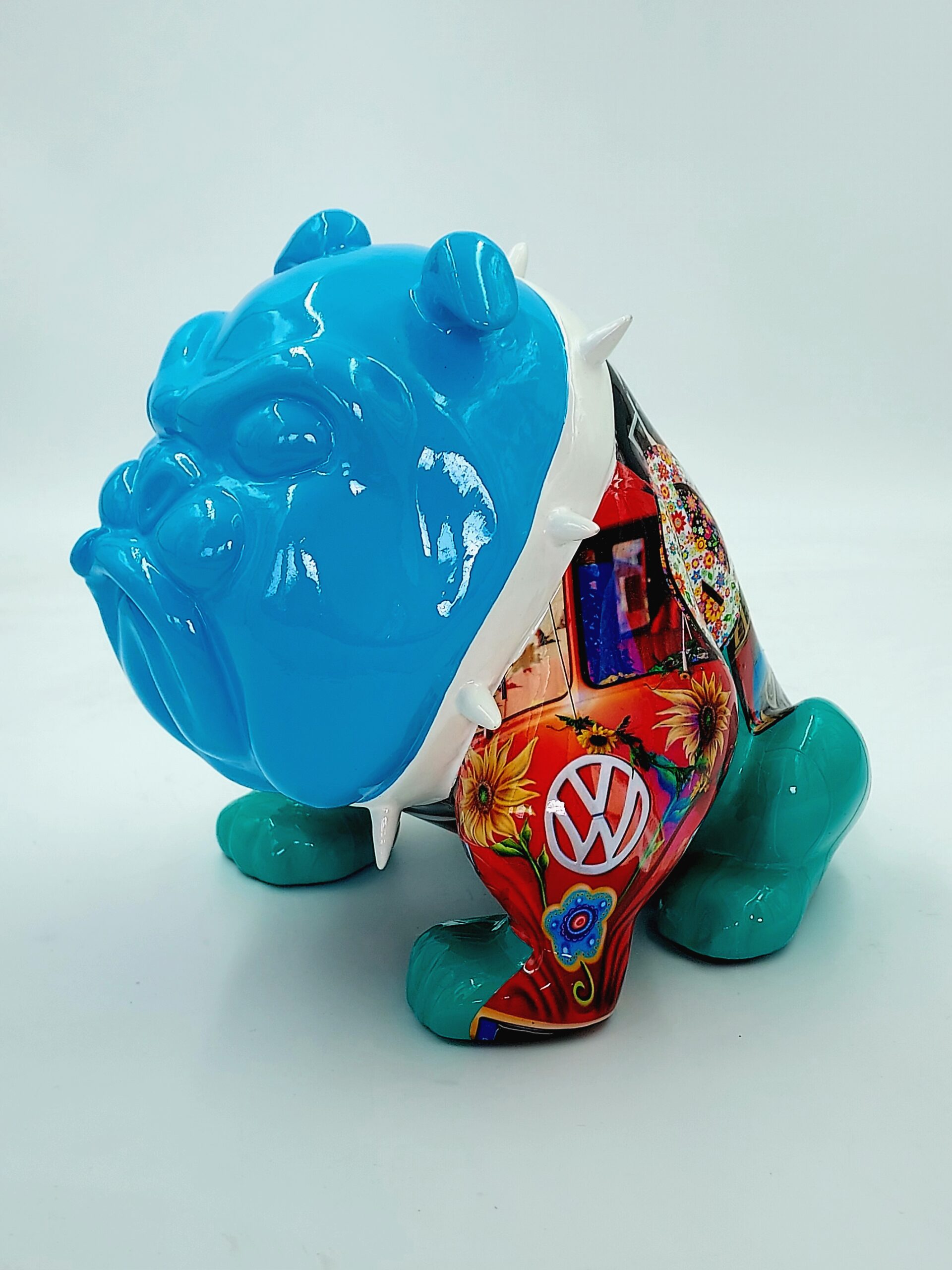 Bulldog Avella 55cm dog - Volkswagen 1 Colorful bulldog figurine with a blue head, turquoise legs, and a vibrant, patterned body featuring floral designs and a Volkswagen logo.