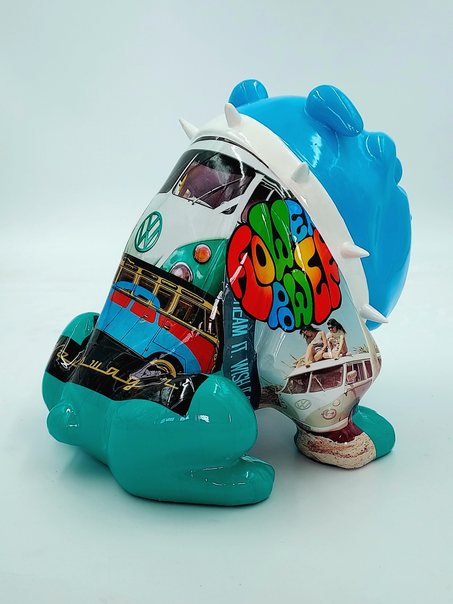 Bulldog Avella 55cm dog - Volkswagen 3 A colorful statue featuring a blue creature with visible white spikes. The creature's body is adorned with artwork of vintage Volkswagen buses and a vibrant