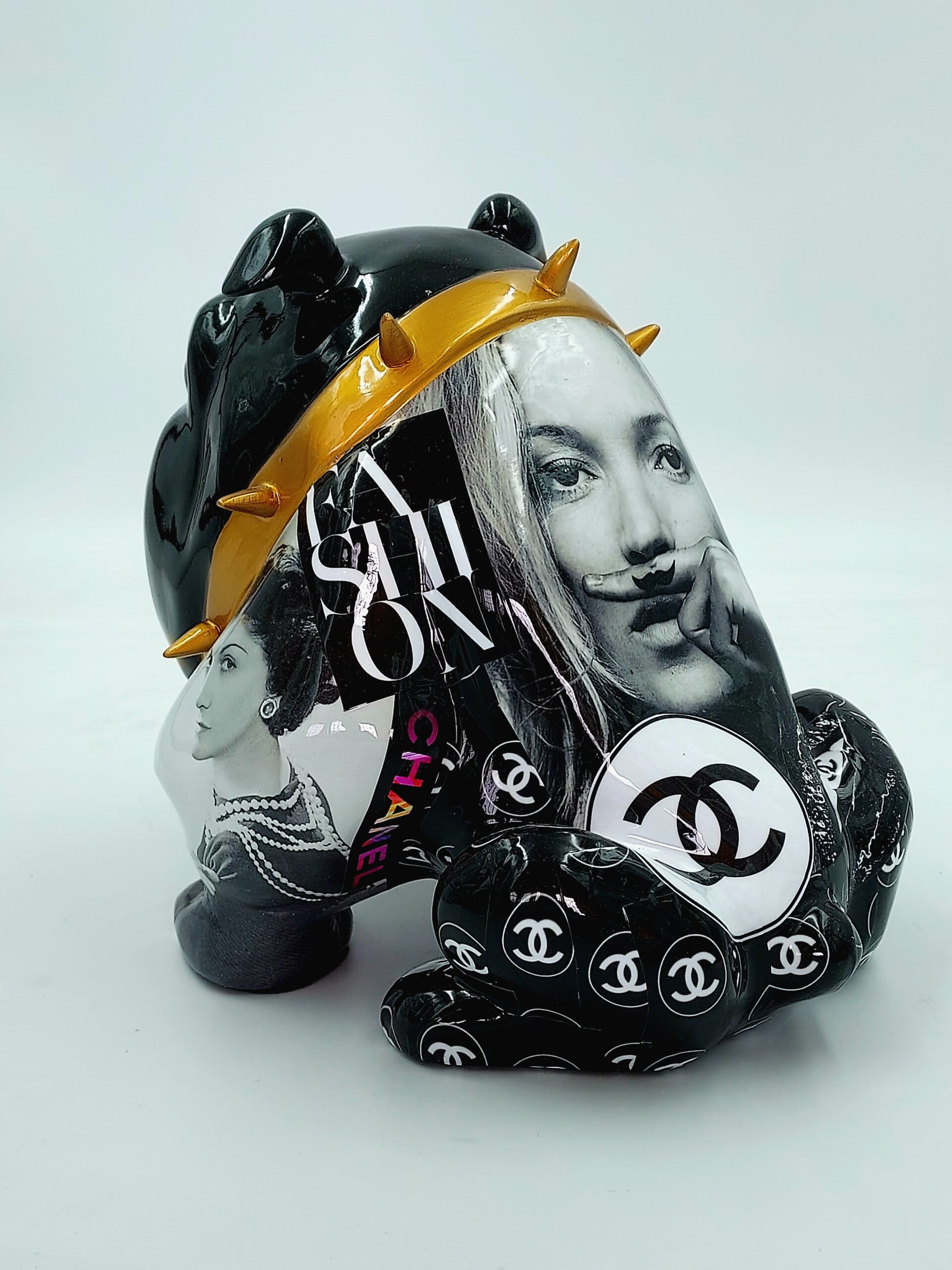 Bulldog Avella 55cm dog - Coco 2 Black sculpture of a bear adorned with fashion magazine cutouts, gold spikes, and Chanel logos.