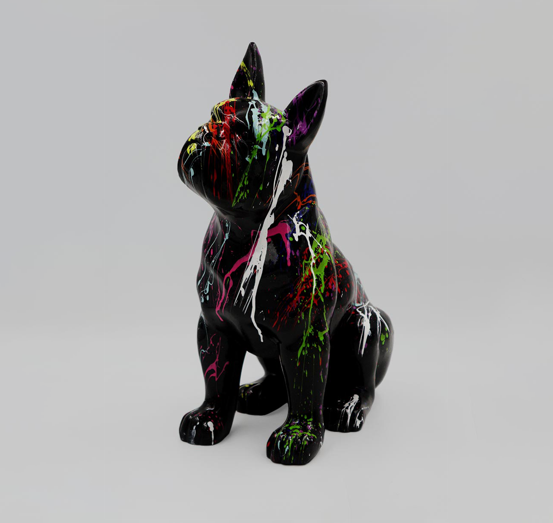 Boston Bulldog M - black trash 1 Black dog sculpture with vibrant paint splashes in various colors on a gray background.