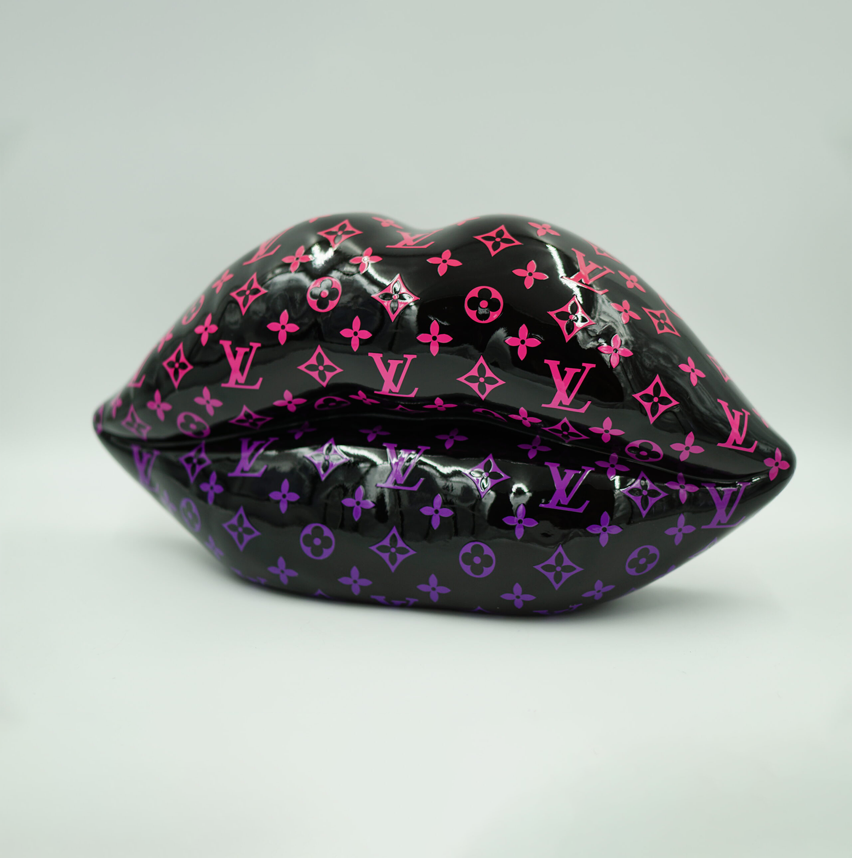 Black lips with monogram - pink gradient. 1 Glossy black sculpture of lips ornamented with pink and purple Louis Vuitton monogram pattern.