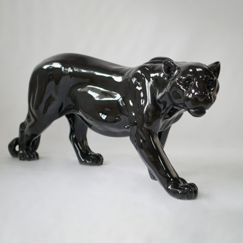 Glossy black panther statue in a prowling position on a plain white background.