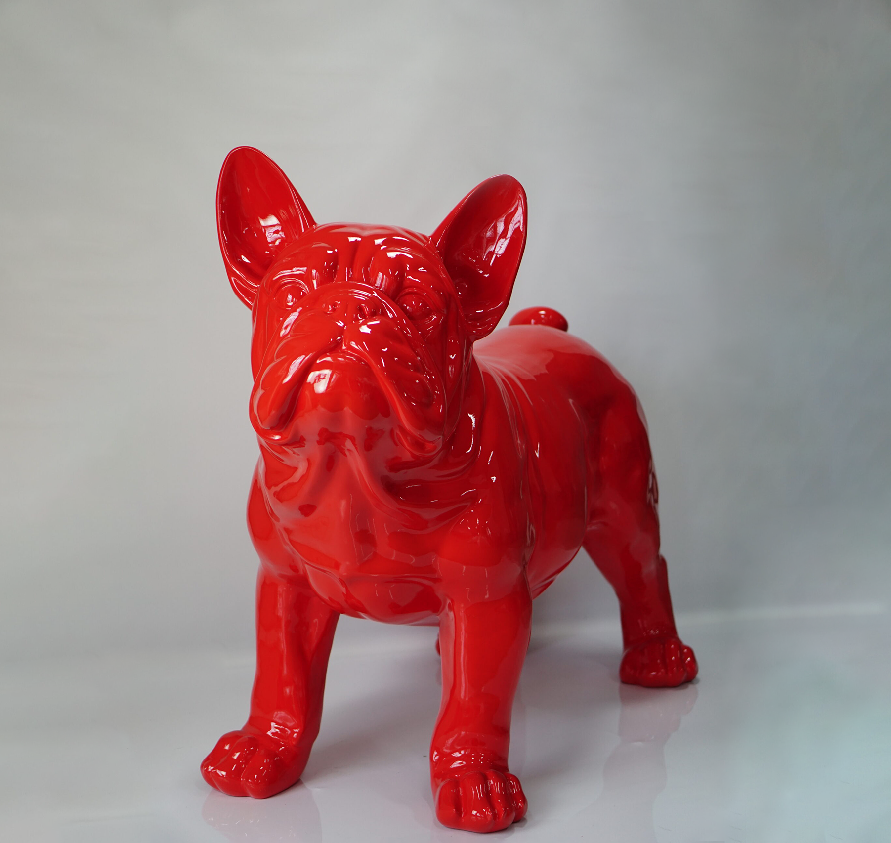 Large French Bulldog Figure Bright red bulldog sculpture with a glossy finish against a plain background.