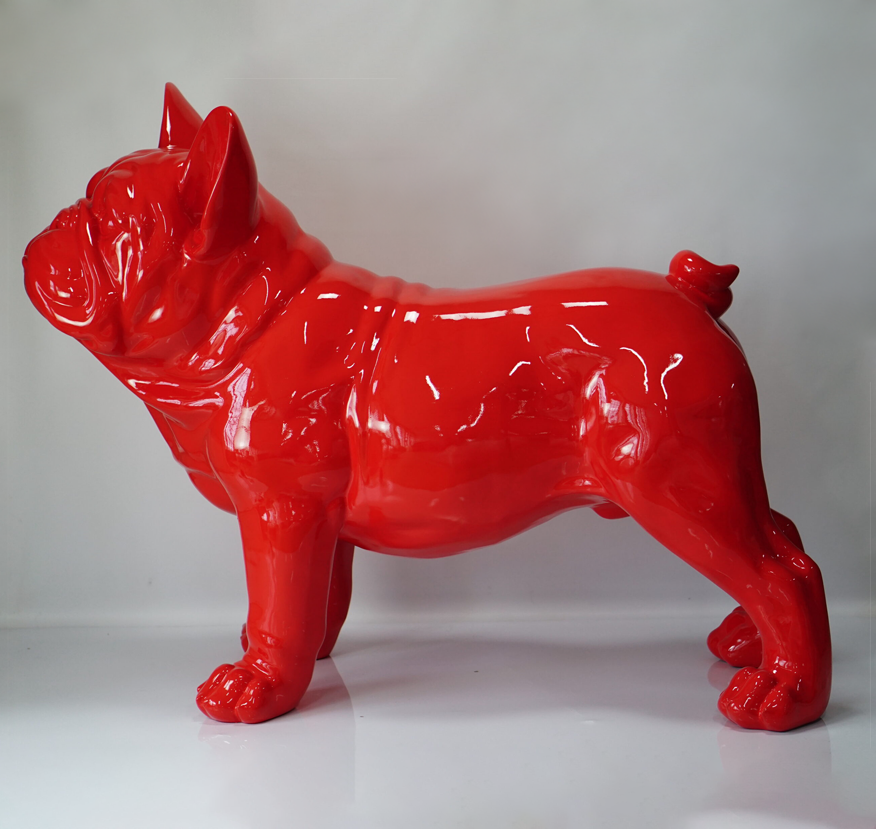 Large French Bulldog Figure Red glossy statue of a standing bulldog on a white background.