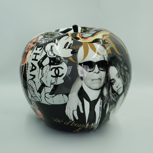 Decorative spherical object with a collage of fashion-related images, including illustrations of Mickey Mouse, Chanel logos, and black-and-white portraits of individuals.