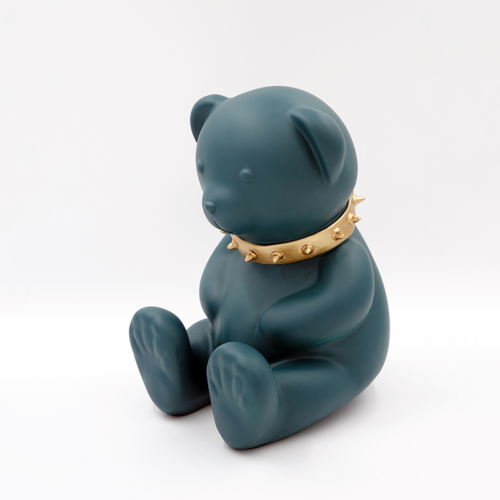 Green bear figurine with a gold spiked collar.