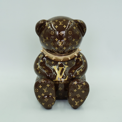 Brown bear figurine with gold Louis Vuitton monogram print and metallic gold collar.
