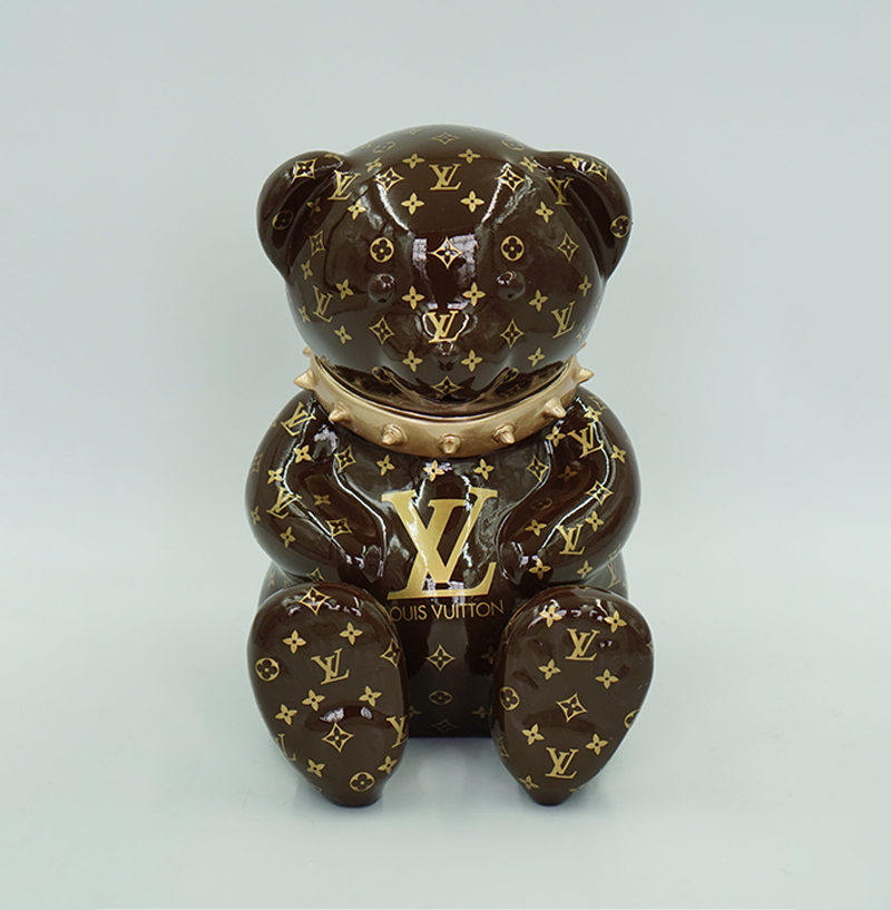 Bear Monogram H-31cm 1 Brown bear figurine with gold Louis Vuitton monogram print and metallic gold collar.