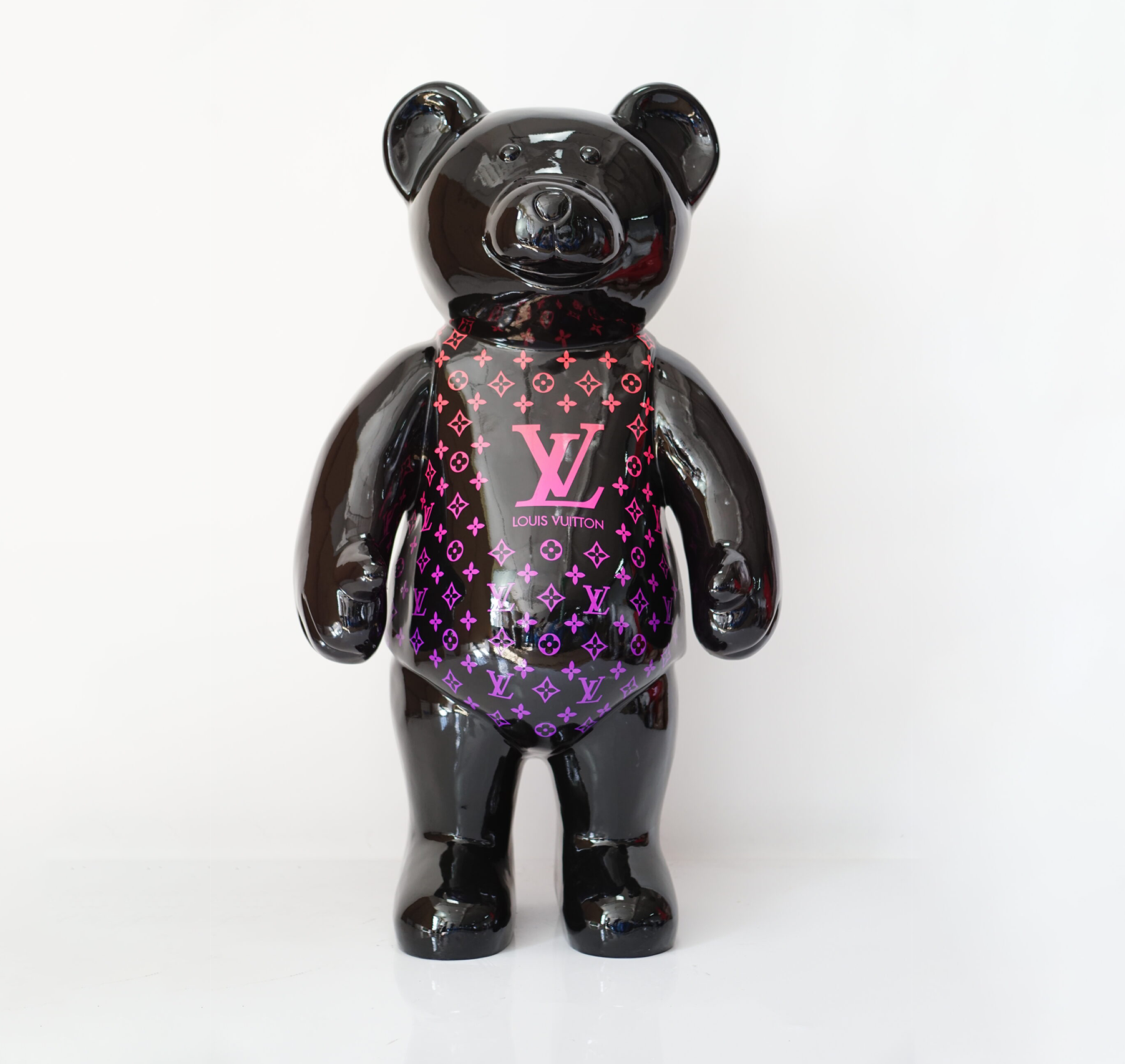 Standing teddy bear monogram - pink gradient 1 Black bear figurine with Louis Vuitton branding in purple and pink on the front.