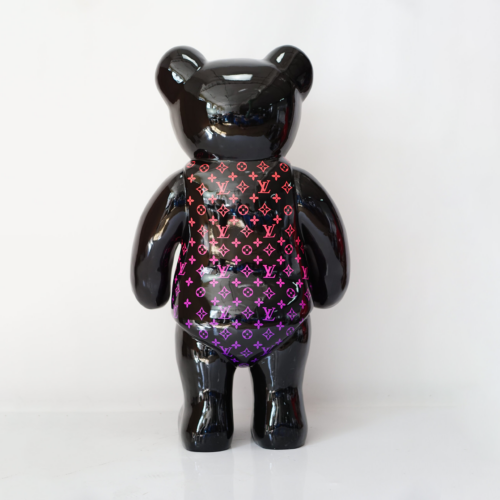 Black bear-shaped figurine with a gradient Louis Vuitton pattern on its back.