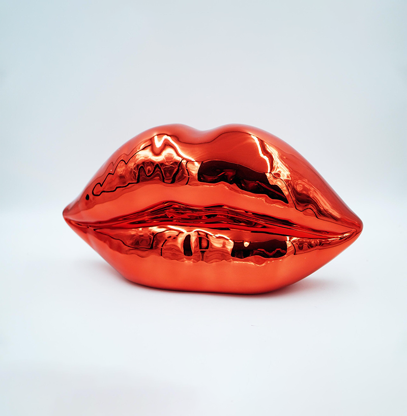 Red Chrome Lips 1 Sculpture of metallic red lips on a plain white background.