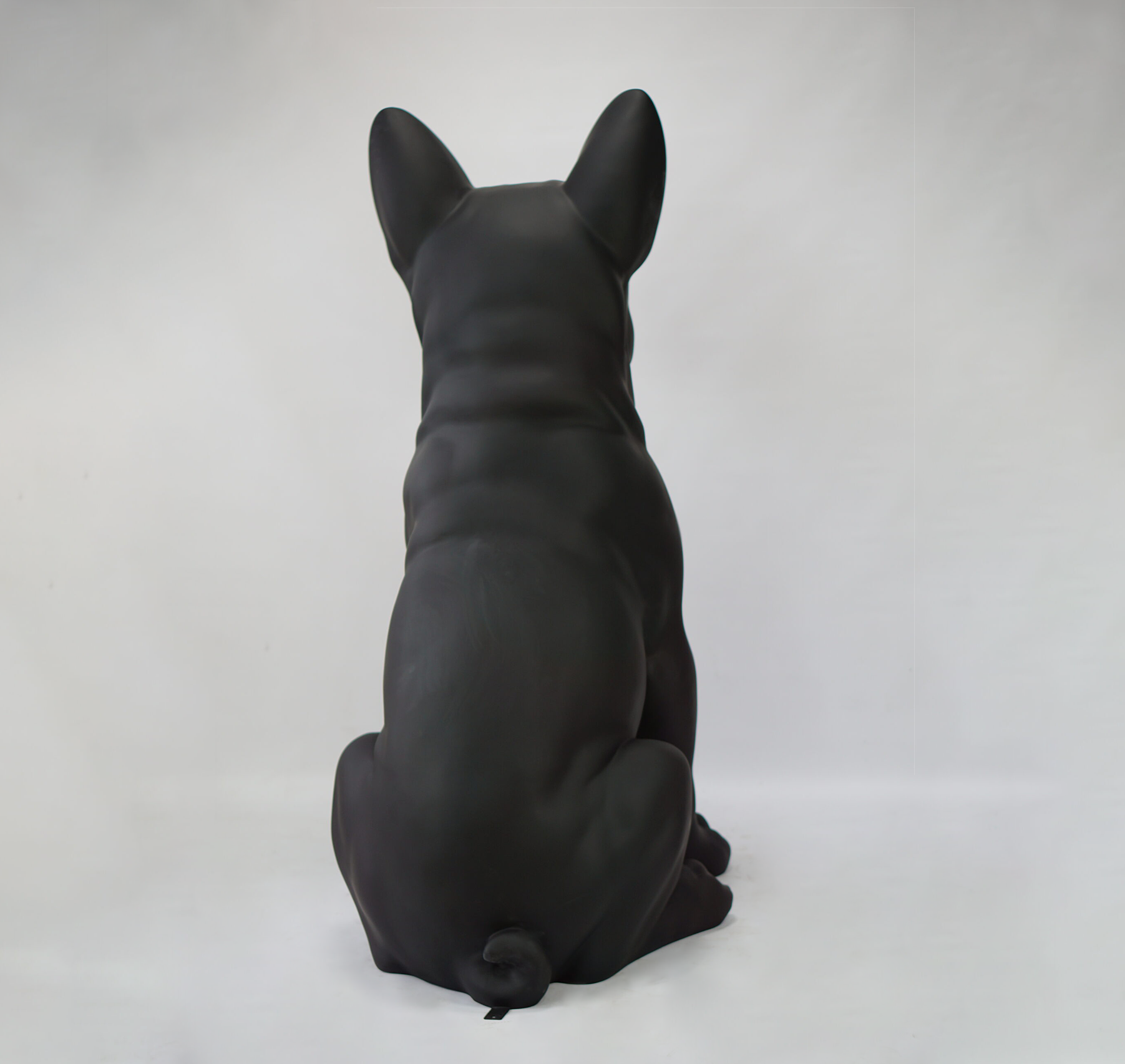 Large French Bulldog Figure A sculpture of a black dog with its back facing the camera against a white background.