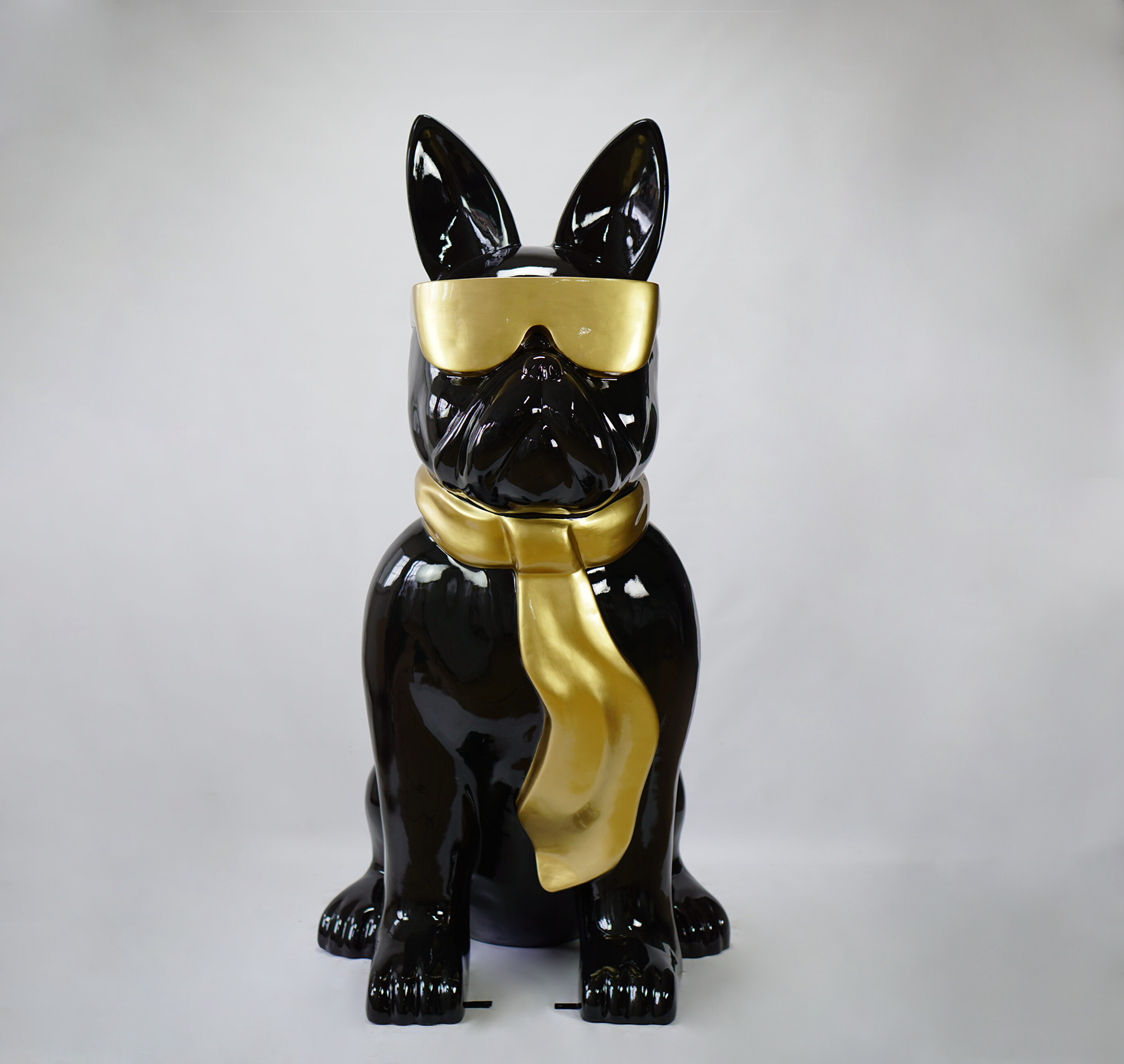 Large bulldog figure with tie and glasses - black gold 2 Black dog statue with golden sunglasses and a golden scarf.