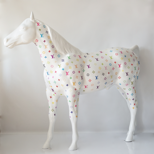 A white horse statue covered in colorful Louis Vuitton logos.